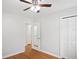 Neutral bedroom features hardwood floors, ceiling fan, and a spacious closet at 1322 Morris Ave, Orlando, FL 32803