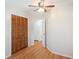 Bedroom featuring wood-look floors, louvred closet, and neutral walls at 1322 Morris Ave, Orlando, FL 32803