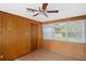 Bright bedroom featuring natural light, ceiling fan, and wood-paneled walls at 1322 Morris Ave, Orlando, FL 32803