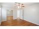 Bedroom featuring gleaming hardwood floors, closet with mirrored doors, and neutral paint at 1322 Morris Ave, Orlando, FL 32803