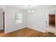Cozy room with hardwood floors, light fixture and a window for natural light at 1322 Morris Ave, Orlando, FL 32803