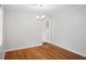 Bright dining area with hardwood floors, simple chandelier and neutral wall color at 1322 Morris Ave, Orlando, FL 32803