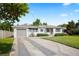 Well-maintained home with an attached garage, long driveway, and attractive landscaping at 1322 Morris Ave, Orlando, FL 32803