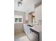 Bright kitchen featuring stainless steel dishwasher, double sink, white cabinets, and ample counter space at 1322 Morris Ave, Orlando, FL 32803