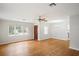 Inviting living room featuring hardwood floors, ceiling fan, and ample natural light at 1322 Morris Ave, Orlando, FL 32803