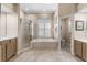 Bathroom featuring a glass-enclosed shower, soaking tub, and separate vanities for added convenience and style at 13478 Summer Rain Dr, Orlando, FL 32828