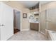 Bathroom featuring a glass-enclosed shower, soaking tub, and separate vanities for added convenience at 13478 Summer Rain Dr, Orlando, FL 32828