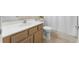 Neutral toned bathroom features a single sink vanity and white toilet with shower and tub at 13478 Summer Rain Dr, Orlando, FL 32828