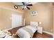Cozy bedroom with a ceiling fan, hardwood floors, and neutral decor providing a peaceful and comfortable space at 13478 Summer Rain Dr, Orlando, FL 32828