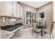 Bright breakfast nook with a mosaic backsplash and windows overlooking the backyard at 13478 Summer Rain Dr, Orlando, FL 32828