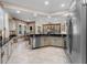 Well-lit kitchen featuring stainless steel appliances, granite countertops, and an open-concept design with a dining area at 13478 Summer Rain Dr, Orlando, FL 32828