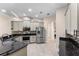 This modern kitchen boasts stainless steel appliances, dark granite countertops and decorative backsplash at 13478 Summer Rain Dr, Orlando, FL 32828