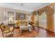 Formal living room with hardwood floors, stylish furniture, and natural light at 13478 Summer Rain Dr, Orlando, FL 32828