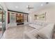 Bright living room with a large sectional sofa, modern entertainment center, and sliding doors to the outdoor area at 13478 Summer Rain Dr, Orlando, FL 32828