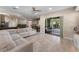 Open-concept living area with a large sectional sofa and access to the patio at 13478 Summer Rain Dr, Orlando, FL 32828