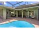 Expansive pool area features ample seating, tropical decor, and a covered patio for relaxing and entertaining at 13478 Summer Rain Dr, Orlando, FL 32828