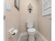 Small half bathroom features a standard toilet, and neutral decor, perfect for guests at 13478 Summer Rain Dr, Orlando, FL 32828