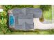 Aerial view of the home with a screened pool, well-manicured lawns, mature trees, and brick driveway at 1350 Lyndale Blvd, Winter Park, FL 32789