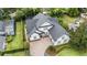 Aerial view of a well-maintained house, lush landscaping, and a screened-in pool area at 1350 Lyndale Blvd, Winter Park, FL 32789