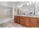 Bathroom showcasing double vanity, granite countertops, and a glass-enclosed shower at 1350 Lyndale Blvd, Winter Park, FL 32789