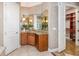 Elegant bathroom featuring custom vanity, stylish fixtures, and seamless access to a walk-in closet at 1350 Lyndale Blvd, Winter Park, FL 32789