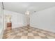 A bright bedroom features elegant tile flooring, ceiling fan, and an en-suite bathroom at 1350 Lyndale Blvd, Winter Park, FL 32789