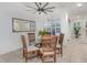 Cozy dining area features a glass table, wooden chairs, and plenty of natural light from the window at 1350 Lyndale Blvd, Winter Park, FL 32789