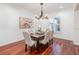 Elegant dining room featuring hardwood floors, a chandelier, and large window with natural light at 1350 Lyndale Blvd, Winter Park, FL 32789