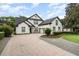 Charming two-story home with a brick driveway, lush landscaping, and a well-manicured lawn at 1350 Lyndale Blvd, Winter Park, FL 32789