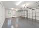 Spacious three car garage with epoxy flooring, bright lighting, and plenty of storage cabinets at 1350 Lyndale Blvd, Winter Park, FL 32789