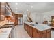 Gourmet kitchen with a center island, wooden cabinets, stainless steel appliances, and tile floors at 1350 Lyndale Blvd, Winter Park, FL 32789