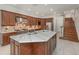 Gourmet kitchen featuring a large island, custom cabinets, stainless steel appliances, and tile floors at 1350 Lyndale Blvd, Winter Park, FL 32789