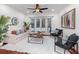Inviting living room with a cozy seating arrangement, French doors leading to the pool, and a ceiling fan at 1350 Lyndale Blvd, Winter Park, FL 32789