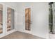 Covered lanai showing decorative doors and brick flooring, offering seamless indoor-outdoor living at 1350 Lyndale Blvd, Winter Park, FL 32789
