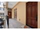 Exterior balcony with brown doors, iron railings, and stone flooring overlooking an outdoor area at 140 E Morse Blvd # C, Winter Park, FL 32789