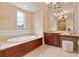 Luxury bathroom with a large soaking tub, vanity and elegant tilework at 140 E Morse Blvd # C, Winter Park, FL 32789