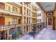 Multi-story courtyard with decorative iron railings, columns, and outdoor seating area at 140 E Morse Blvd # C, Winter Park, FL 32789