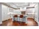 Luxury kitchen featuring white cabinets, granite countertops, and a center island with bar stools at 140 E Morse Blvd # C, Winter Park, FL 32789