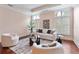 Bright living room featuring hardwood floors, white furniture, and large windows at 140 E Morse Blvd # C, Winter Park, FL 32789