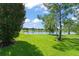 Expansive backyard with lush green grass and a serene lake view, great for outdoor activities at 14897 Evergreen Oak Loop, Winter Garden, FL 34787