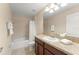 Well lit bathroom featuring a single vanity, granite counters, and shower-tub combo at 14897 Evergreen Oak Loop, Winter Garden, FL 34787