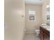 Well-lit powder room features tile flooring, large window, and modern fixtures at 14897 Evergreen Oak Loop, Winter Garden, FL 34787