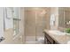 Bathroom featuring a glass enclosed shower, single vanity, and neutral color palette at 14897 Evergreen Oak Loop, Winter Garden, FL 34787