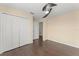 Bedroom featuring hardwood floors, a closet, and a ceiling fan at 14897 Evergreen Oak Loop, Winter Garden, FL 34787