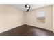 Empty bedroom with a ceiling fan, window, and hardwood flooring at 14897 Evergreen Oak Loop, Winter Garden, FL 34787