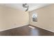 Empty bedroom with hardwood flooring, a window, and a ceiling fan at 14897 Evergreen Oak Loop, Winter Garden, FL 34787