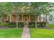 Charming home exterior with manicured landscaping, walkway, and blooming trees at 14897 Evergreen Oak Loop, Winter Garden, FL 34787