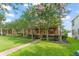 Inviting front exterior showcasing mature trees and a well-maintained lawn and walkway at 14897 Evergreen Oak Loop, Winter Garden, FL 34787