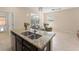 Stylish kitchen island with granite countertop overlooking the living space at 14897 Evergreen Oak Loop, Winter Garden, FL 34787
