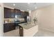Modern kitchen includes granite countertops, stainless steel appliances, and dark wood cabinets at 14897 Evergreen Oak Loop, Winter Garden, FL 34787
